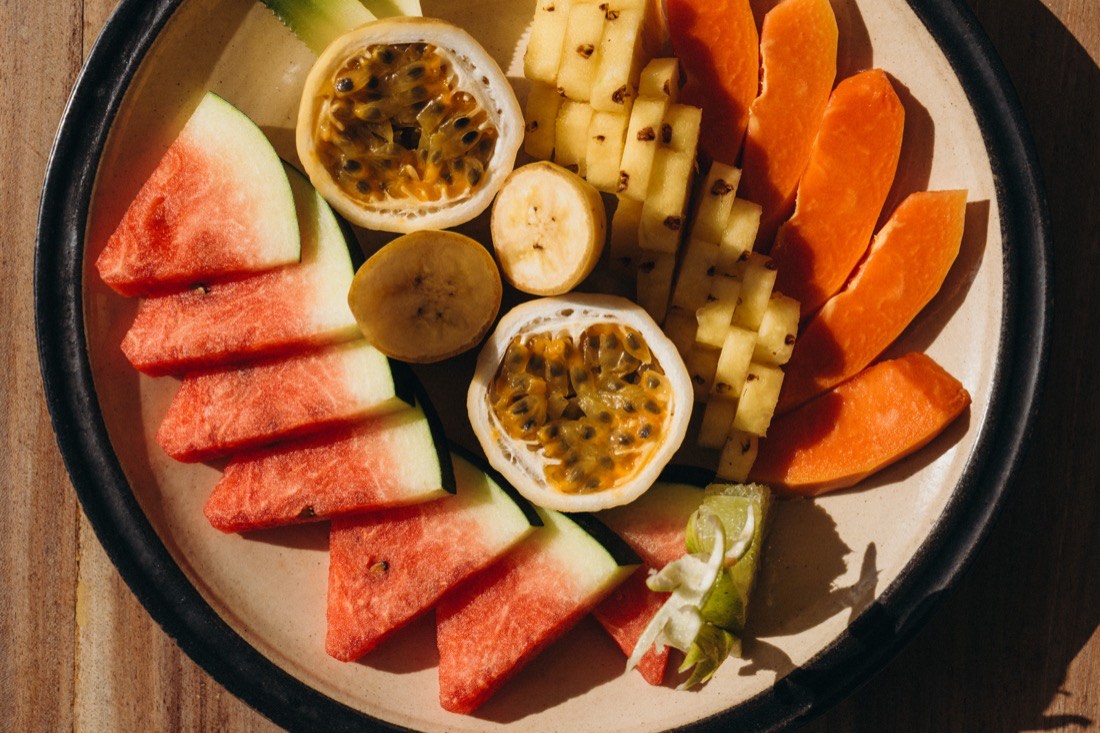 A fresh tropical fruit platter, watermelon, passion fruit, papaya and pineapple, at a yoga retreat in Sri Lanka