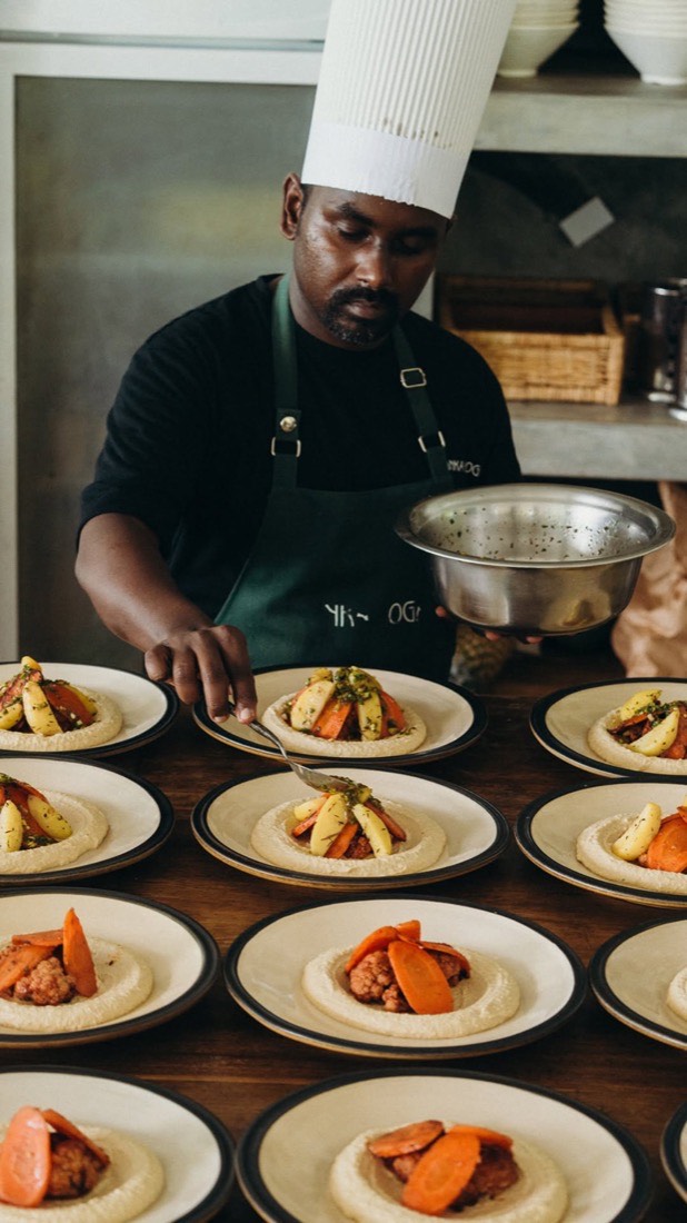 A chef plating fresh vegan dishes in the Lanka Yoga retreat kitchen, Sri Lanka