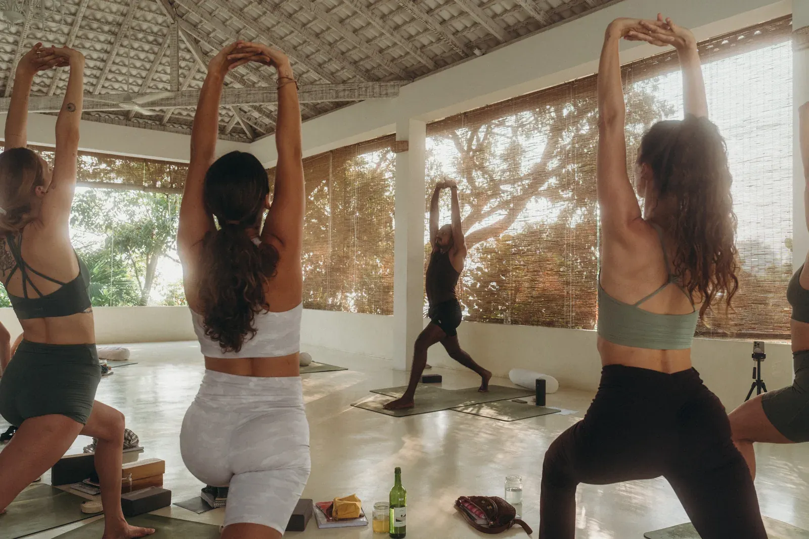 Yoga retreat group practising by Koggala Lake at Lanka Yoga, Sri Lanka